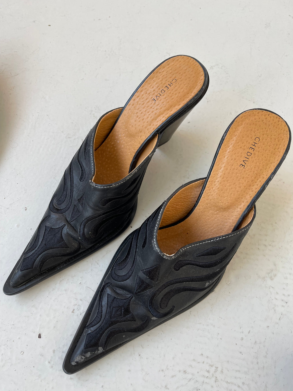 Black western style mules with embroidery detail