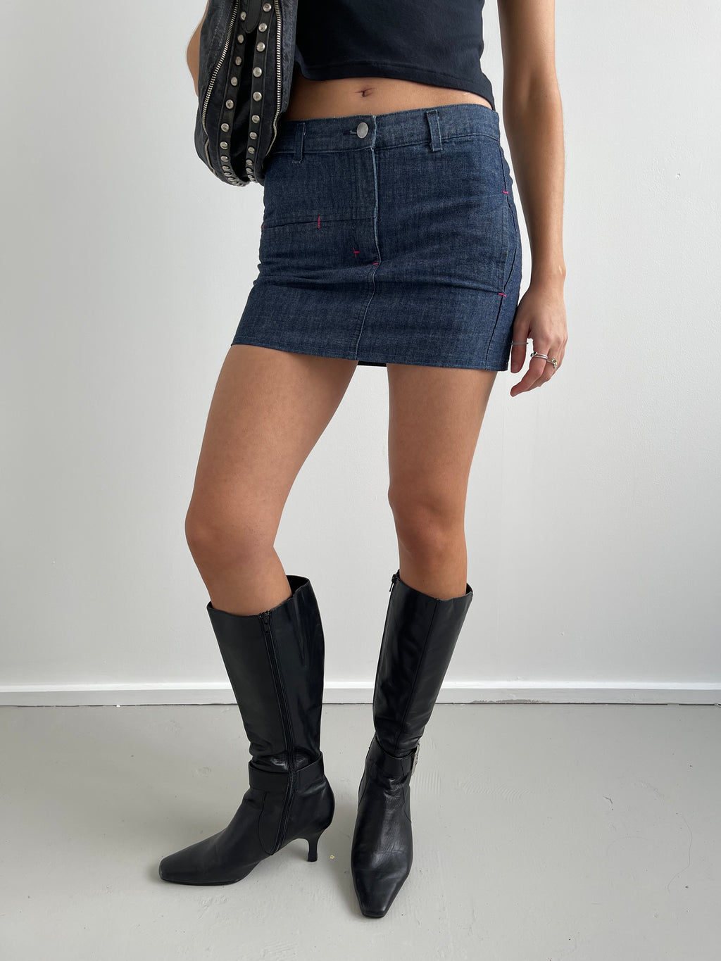 Denim mini skirt with pink top stitching detail