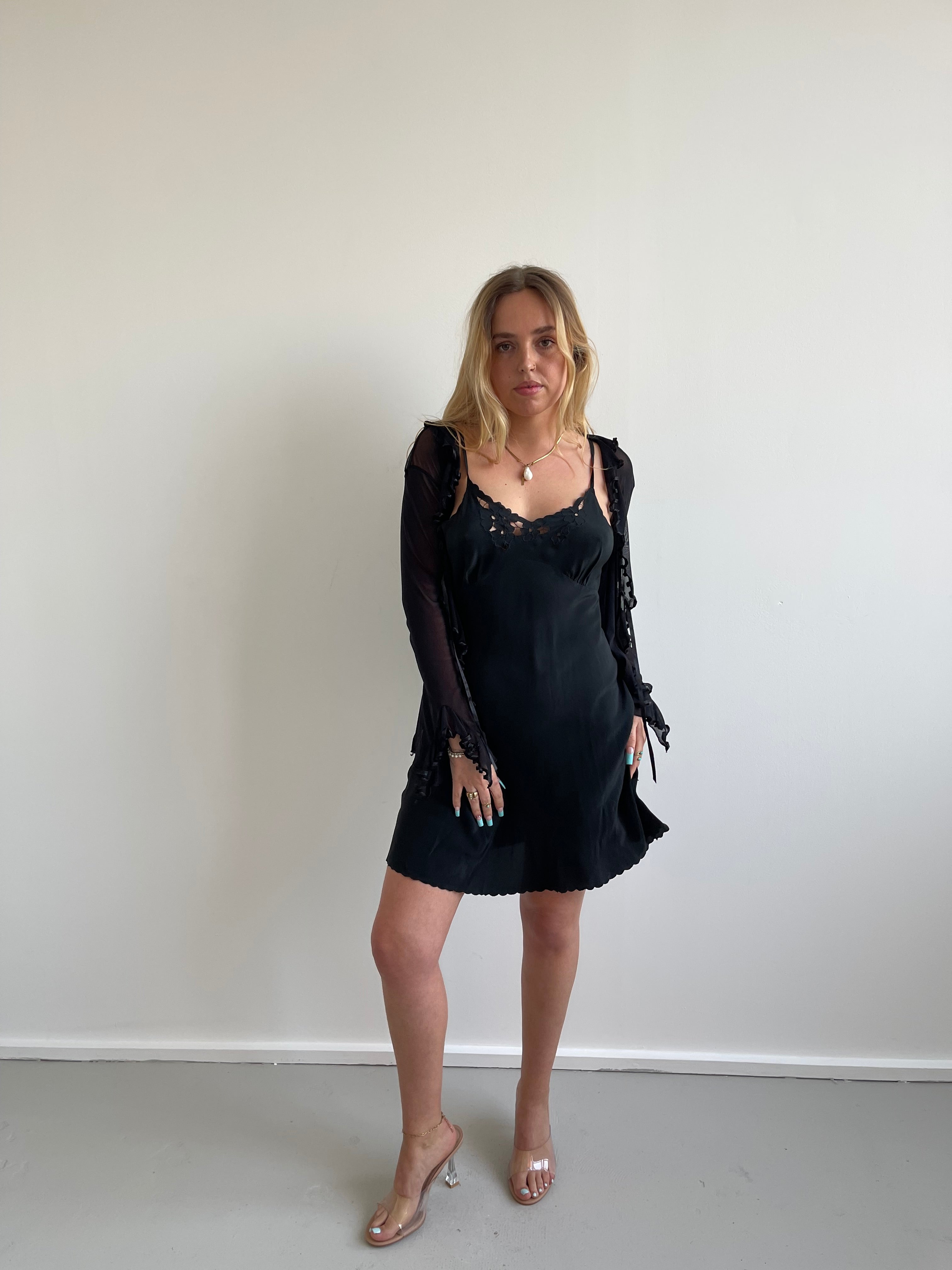Black mesh cardigan with ruffle detail and satin trims