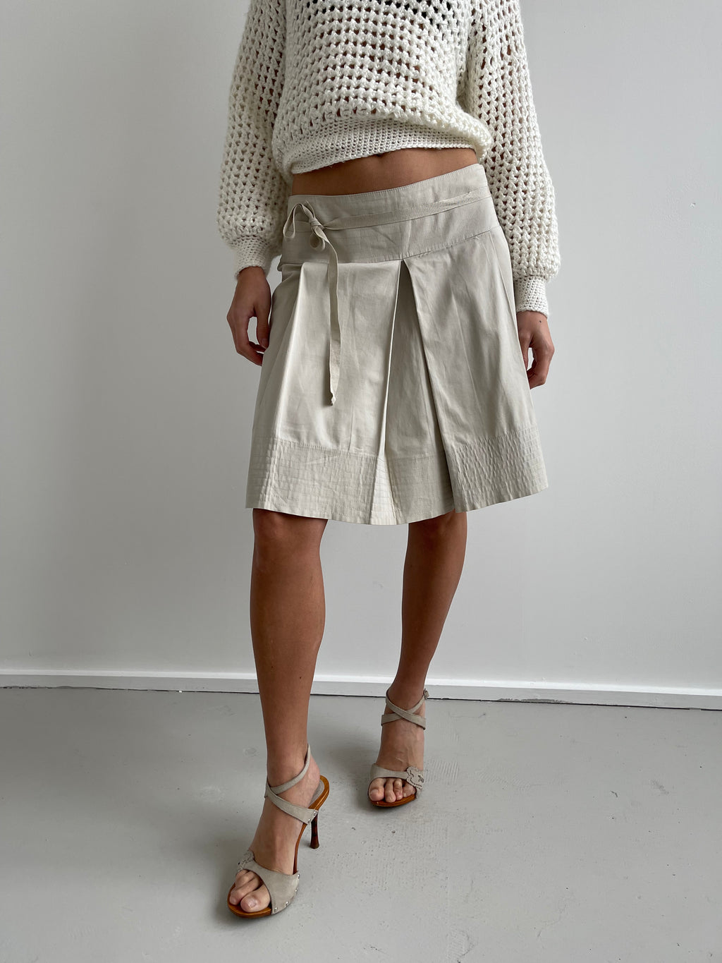 Beige pleated knee length shirt with top stitch trims