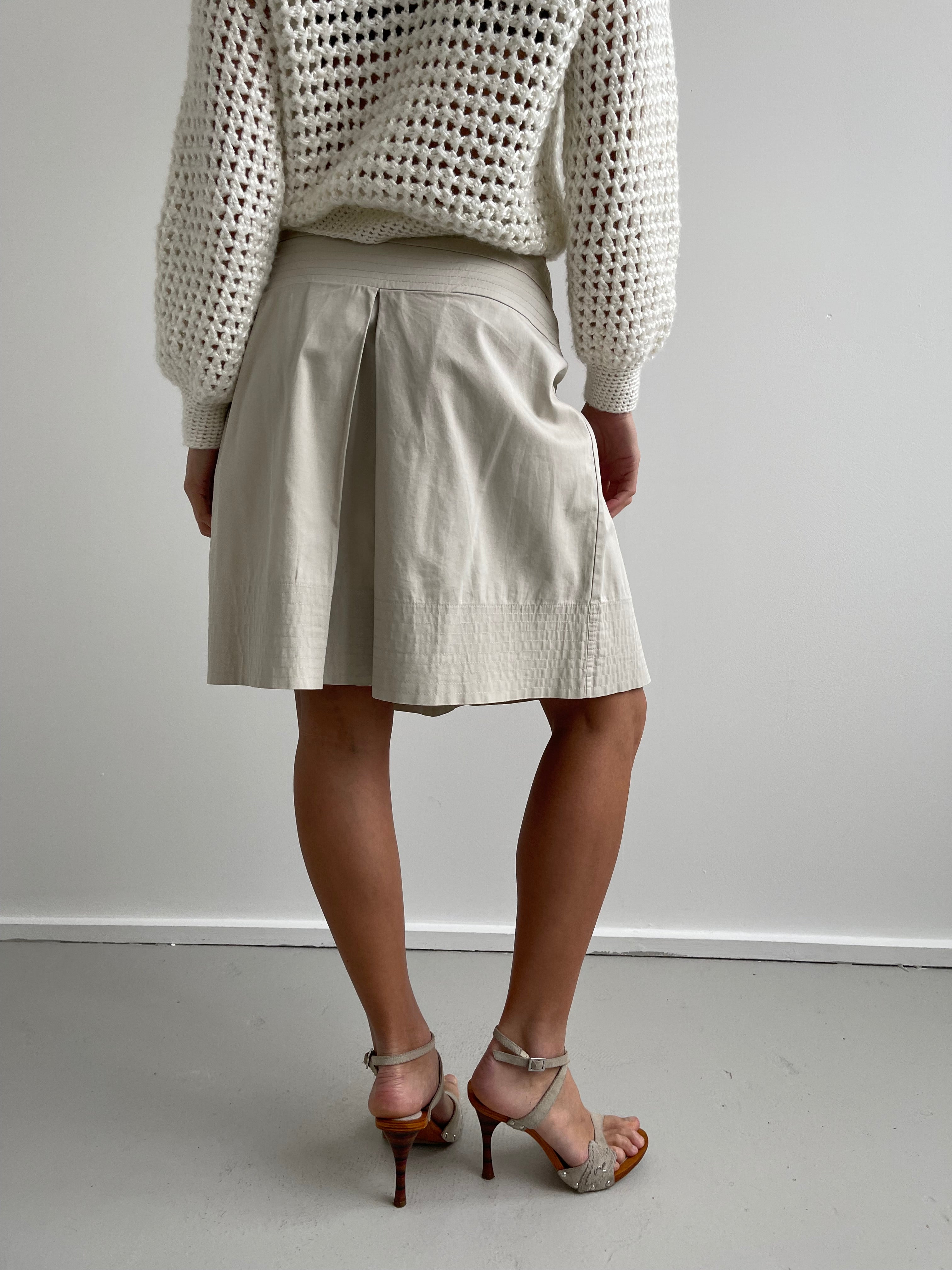 Beige pleated knee length shirt with top stitch trims