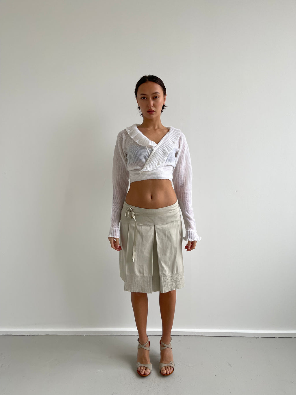White wrap around cardigan with frilly detail