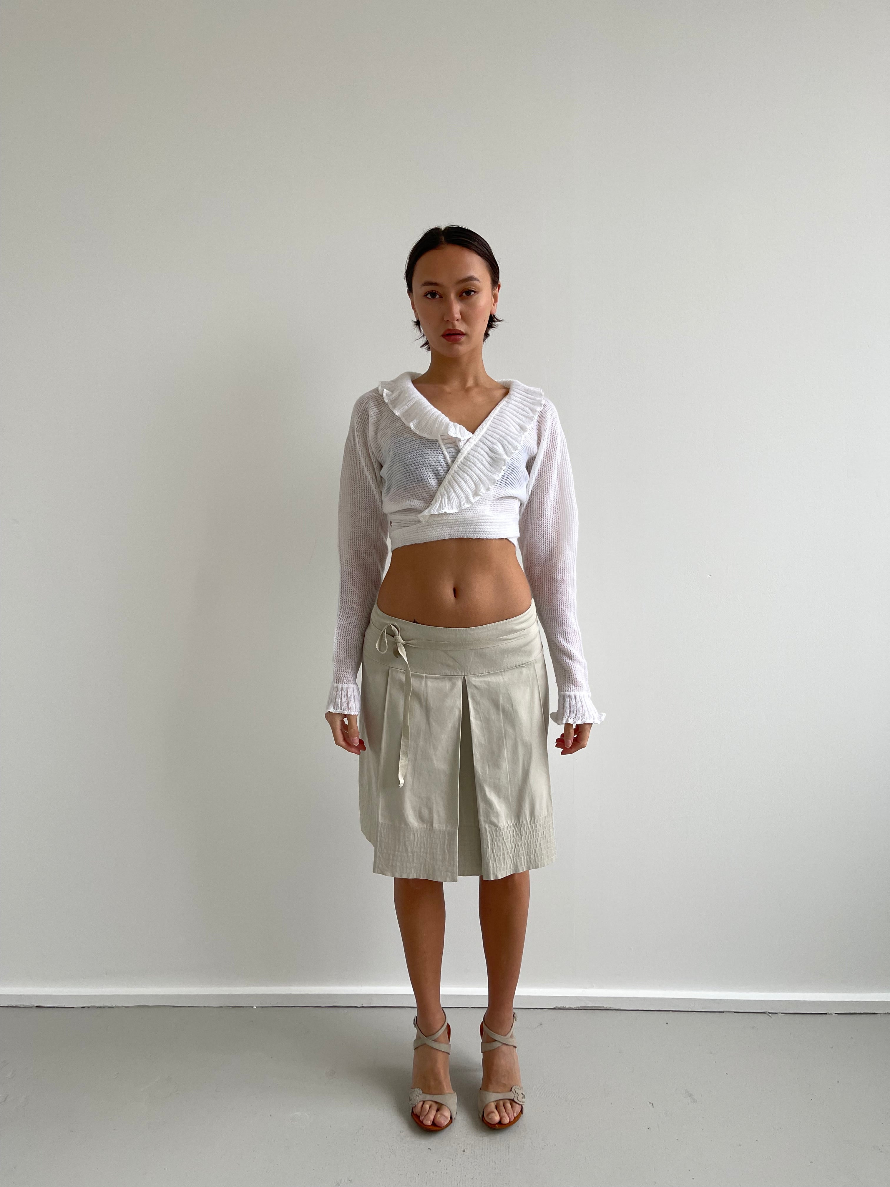White wrap around cardigan with frilly detail