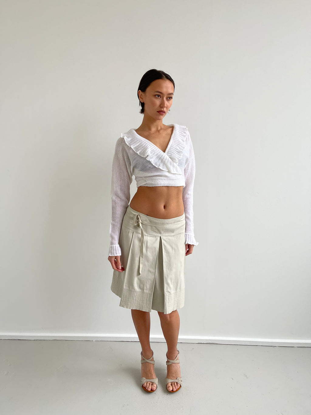 White wrap around cardigan with frilly detail