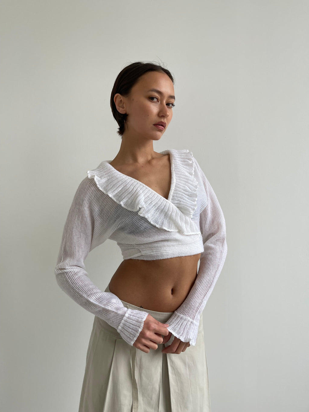 White wrap around cardigan with frilly detail