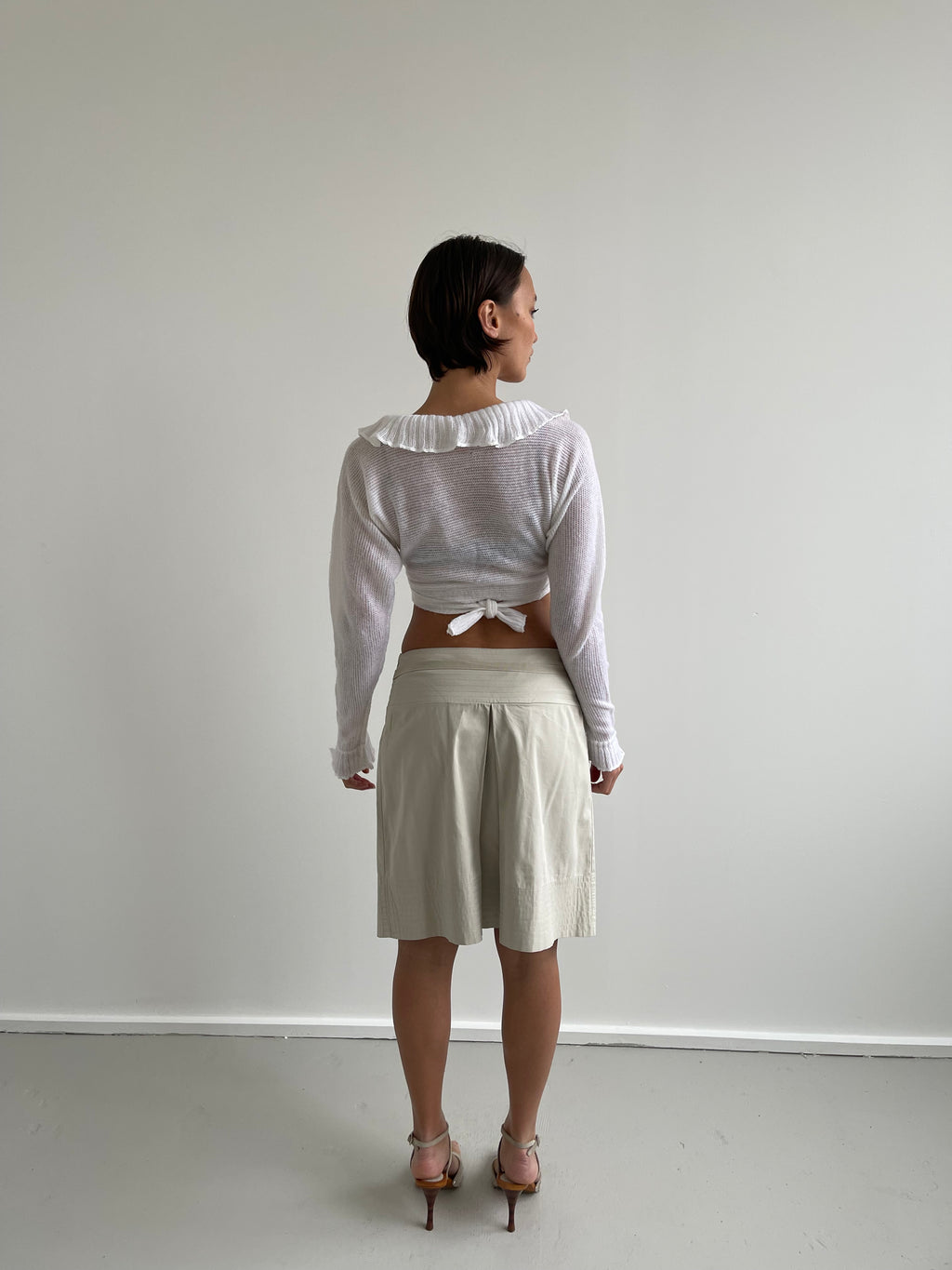White wrap around cardigan with frilly detail