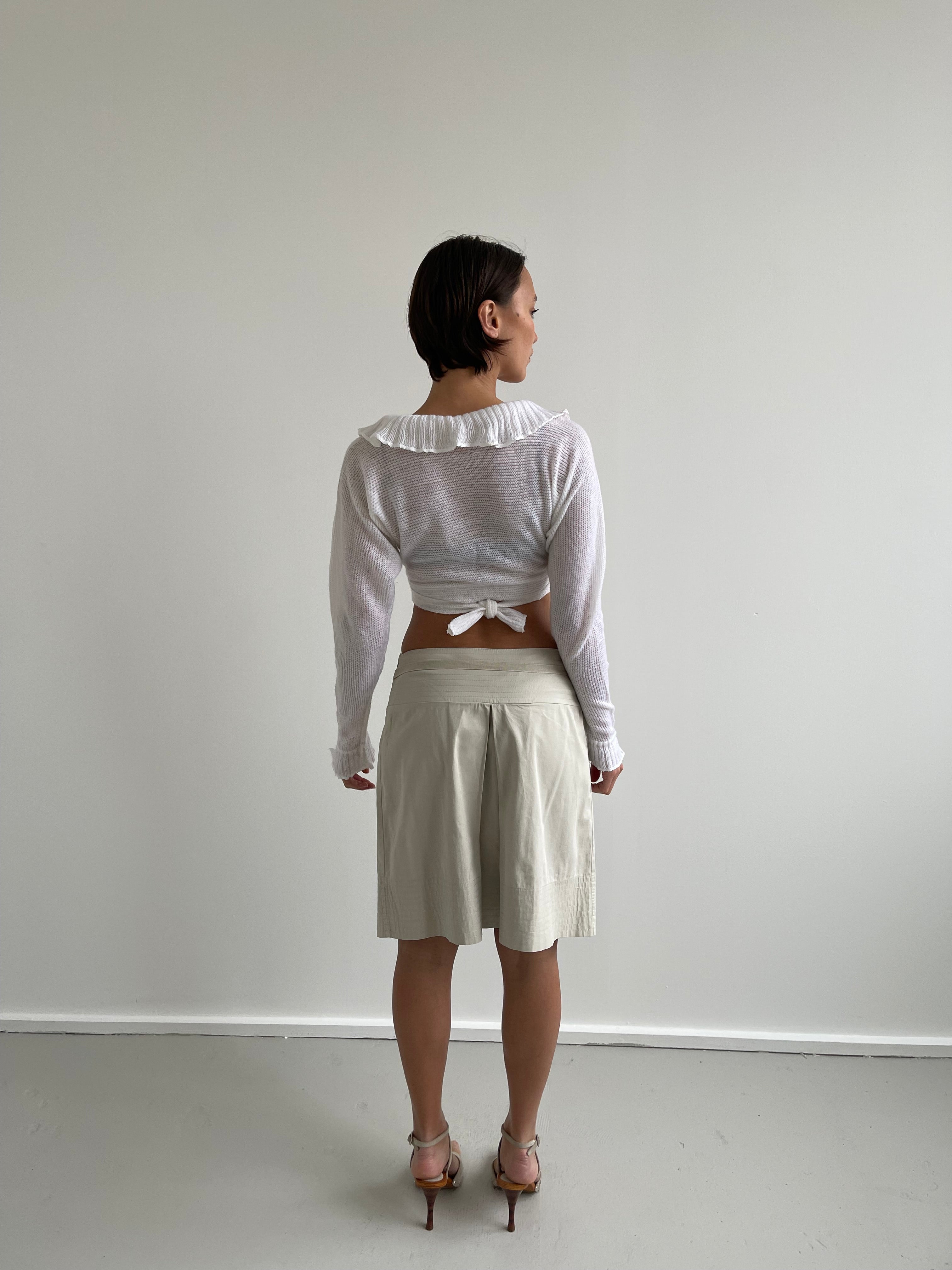 White wrap around cardigan with frilly detail