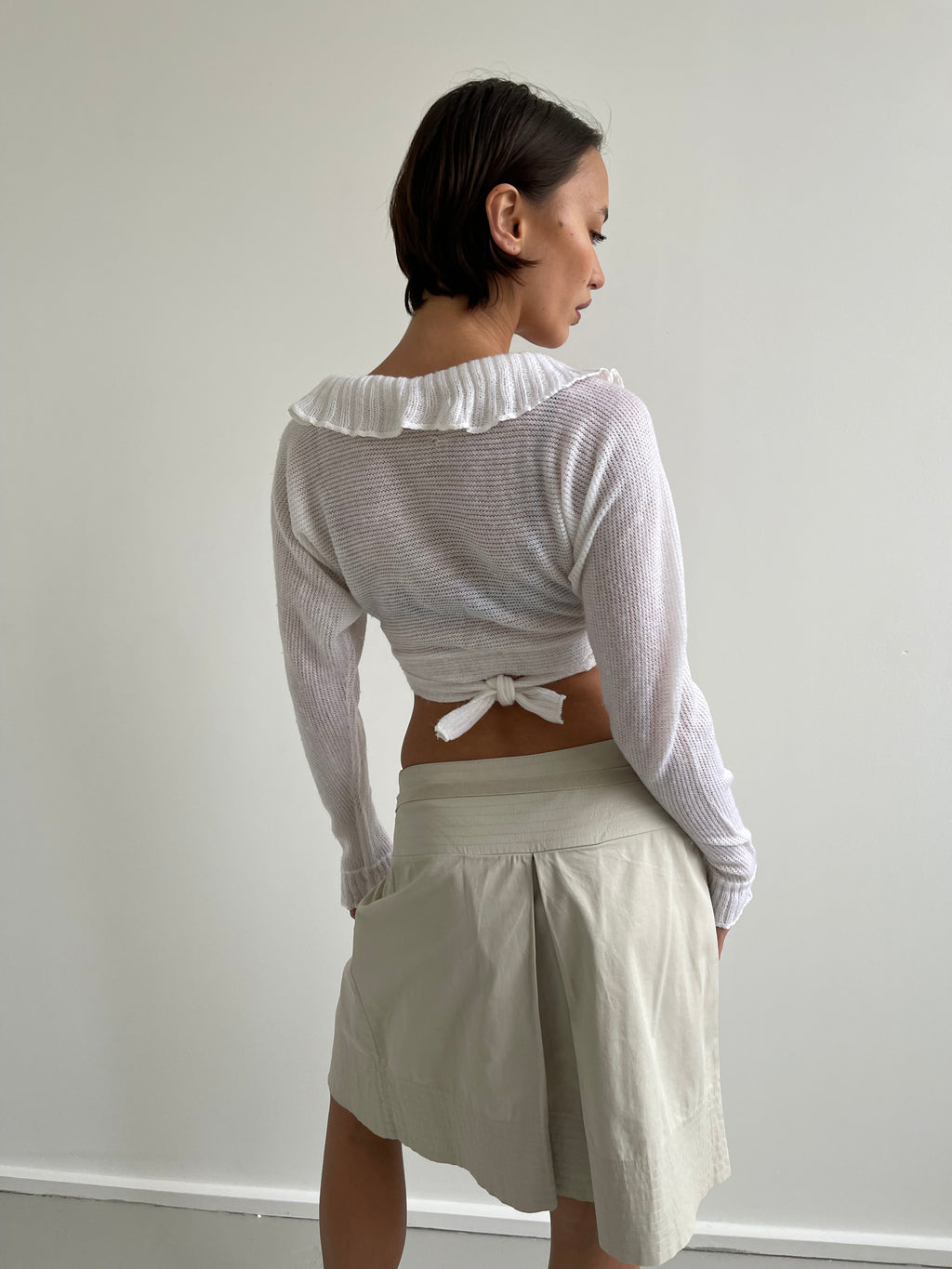 White wrap around cardigan with frilly detail