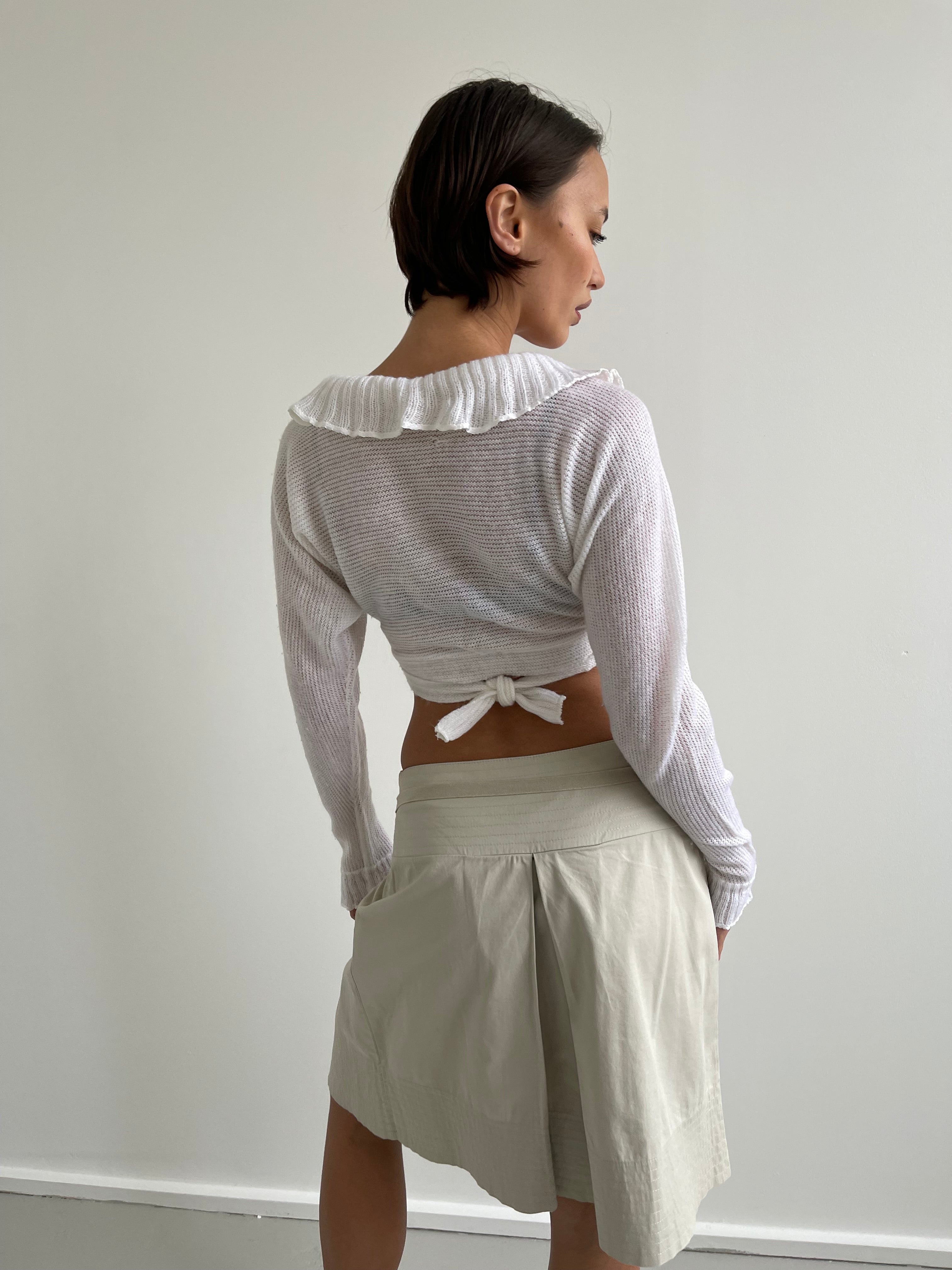 White wrap around cardigan with frilly detail