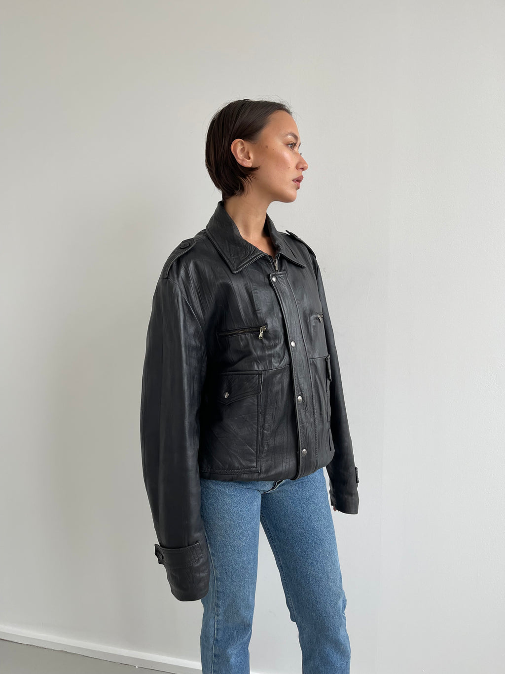 Oversized black leather bomber jacket