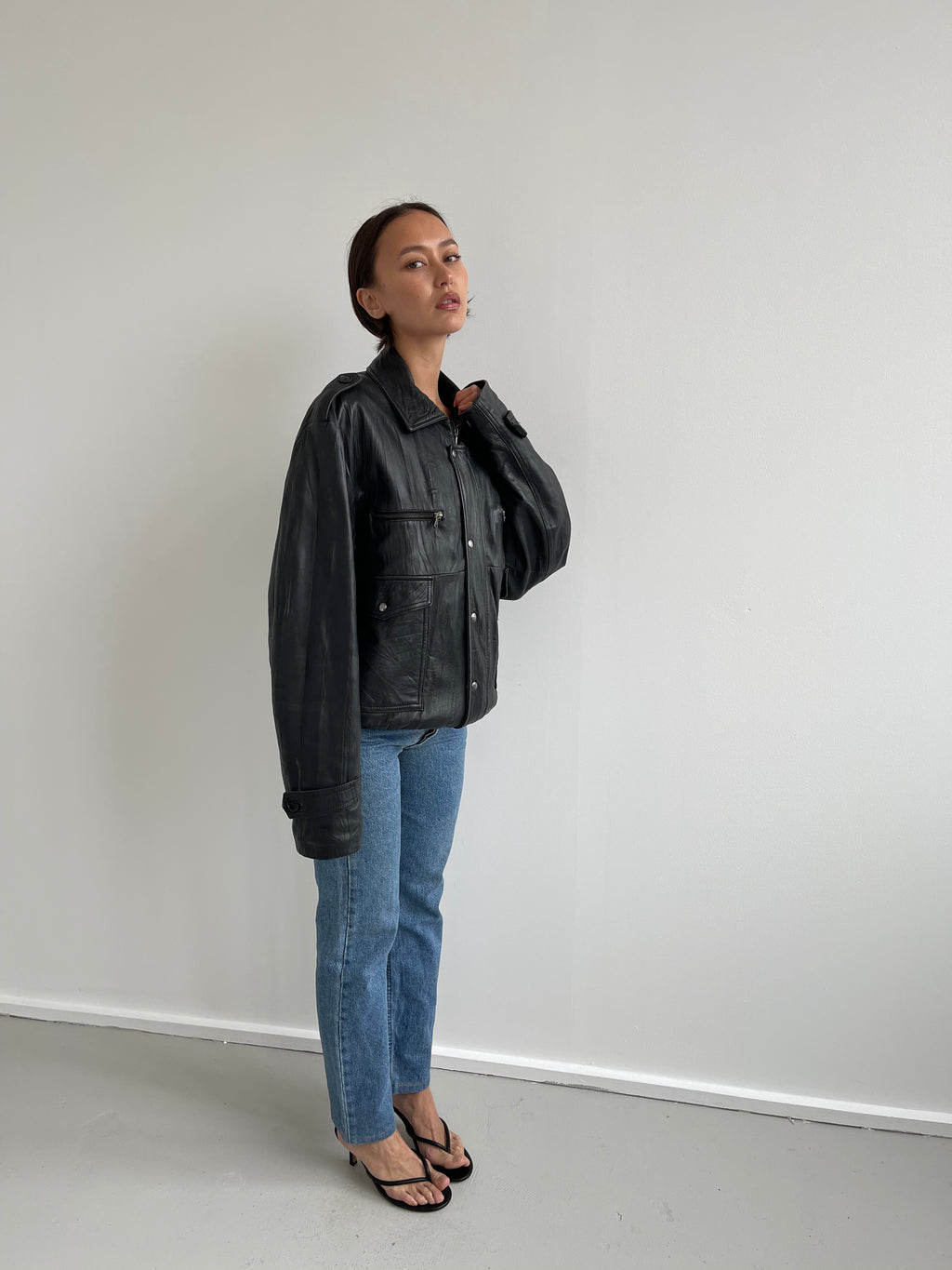 Oversized black leather bomber jacket