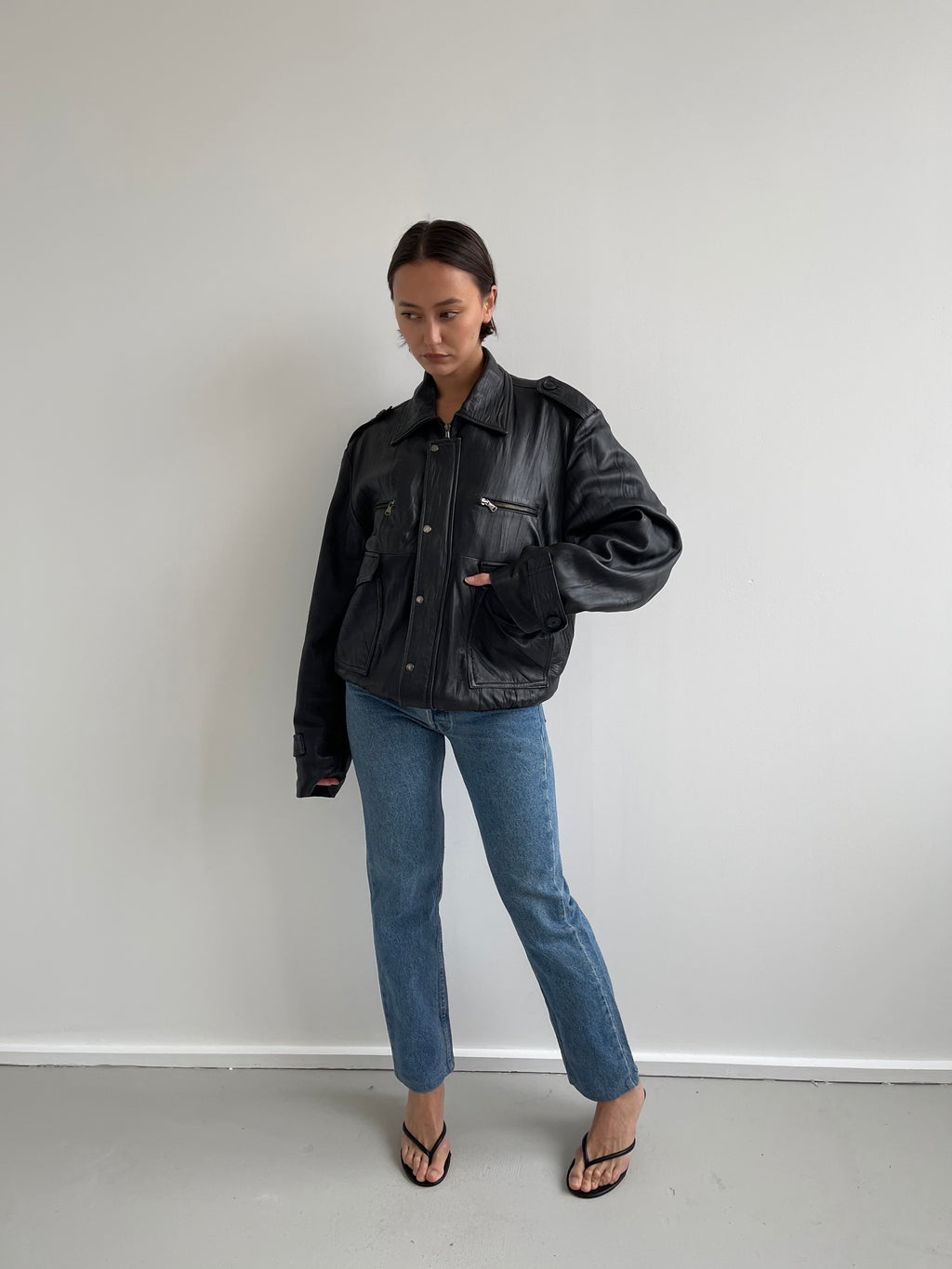 Oversized black leather bomber jacket