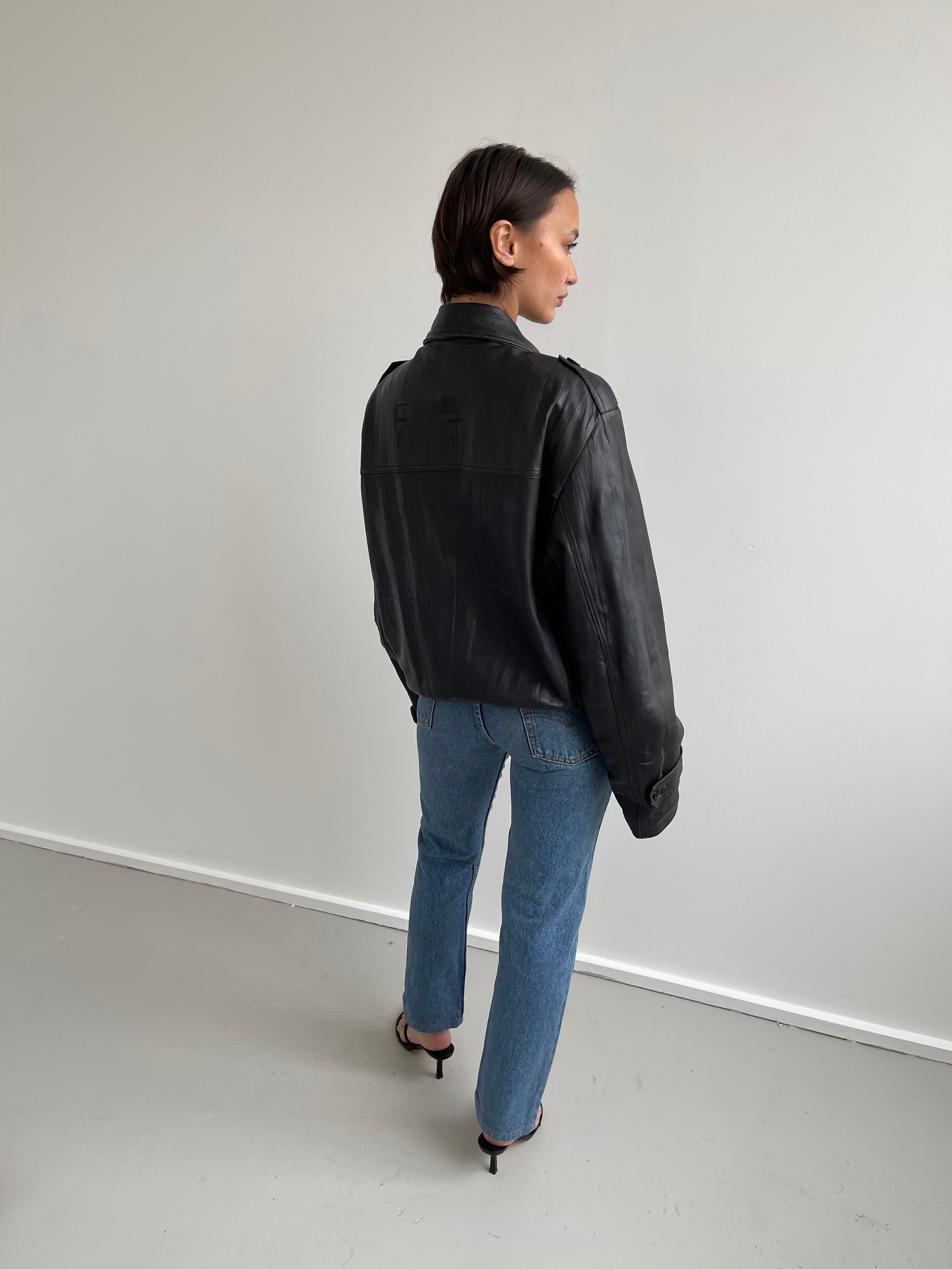 Oversized black leather bomber jacket