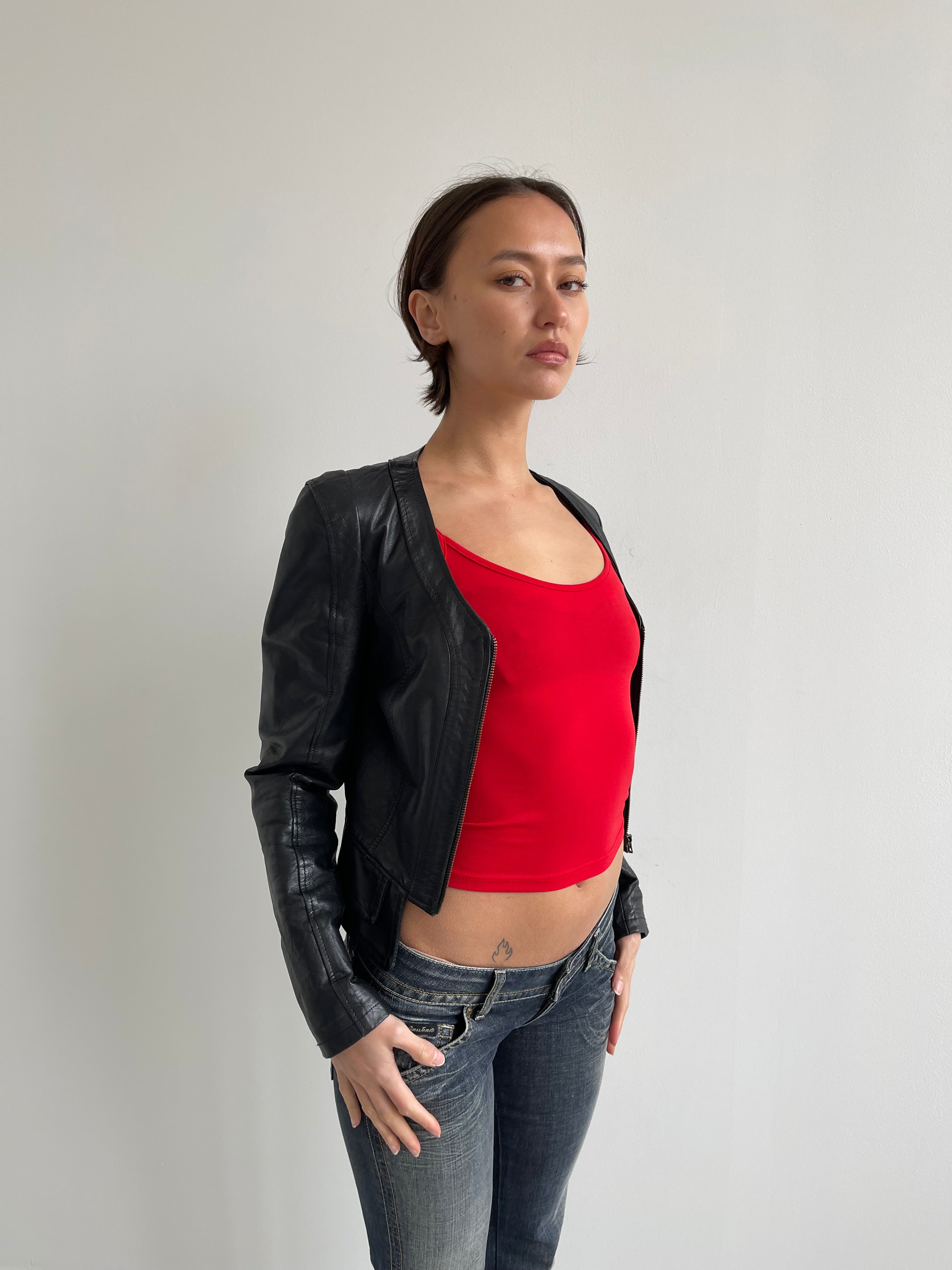 Fitted black leather jacket with panels and low cut neck