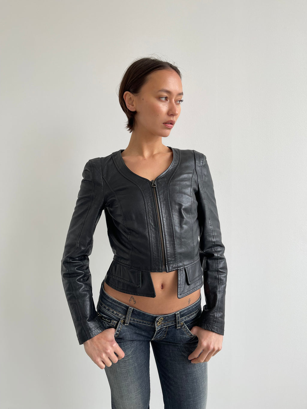 Fitted black leather jacket with panels and low cut neck