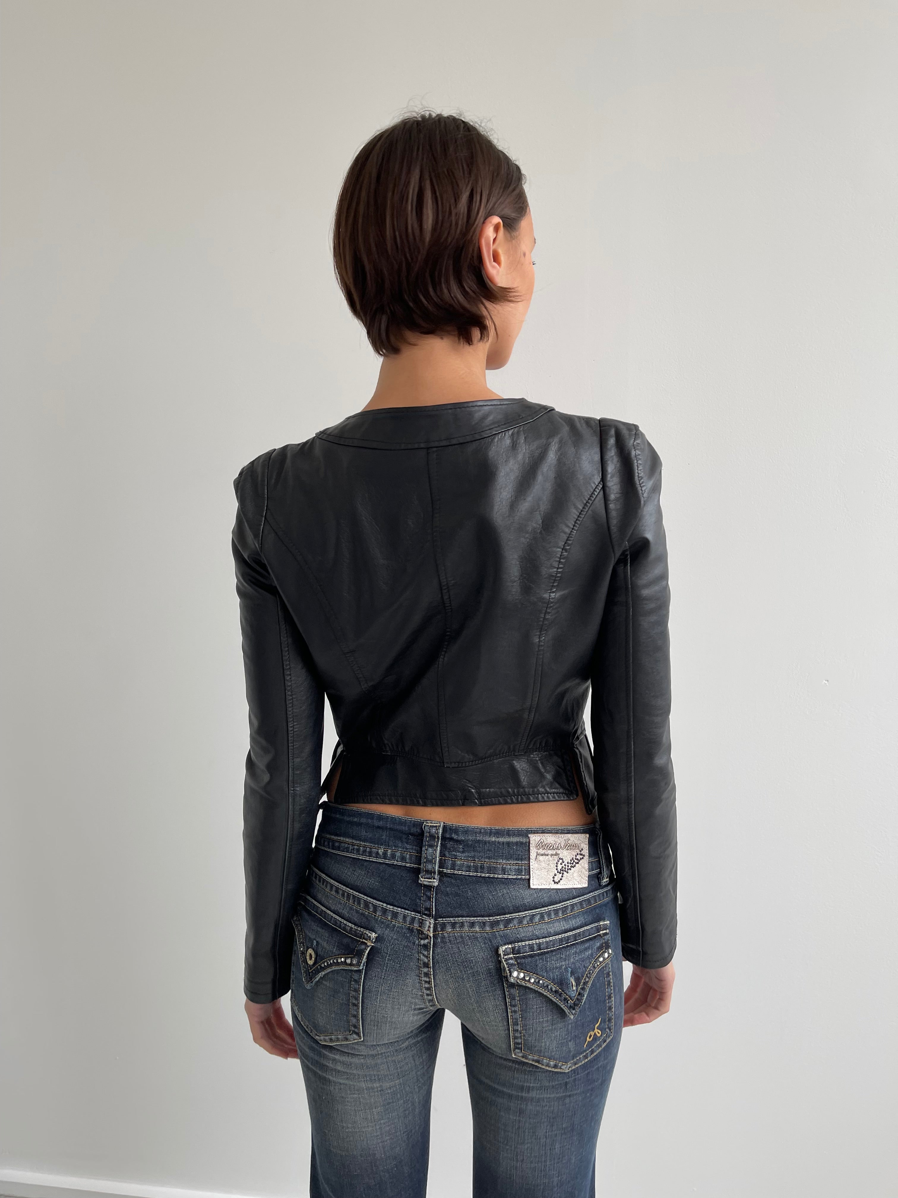Fitted black leather jacket with panels and low cut neck