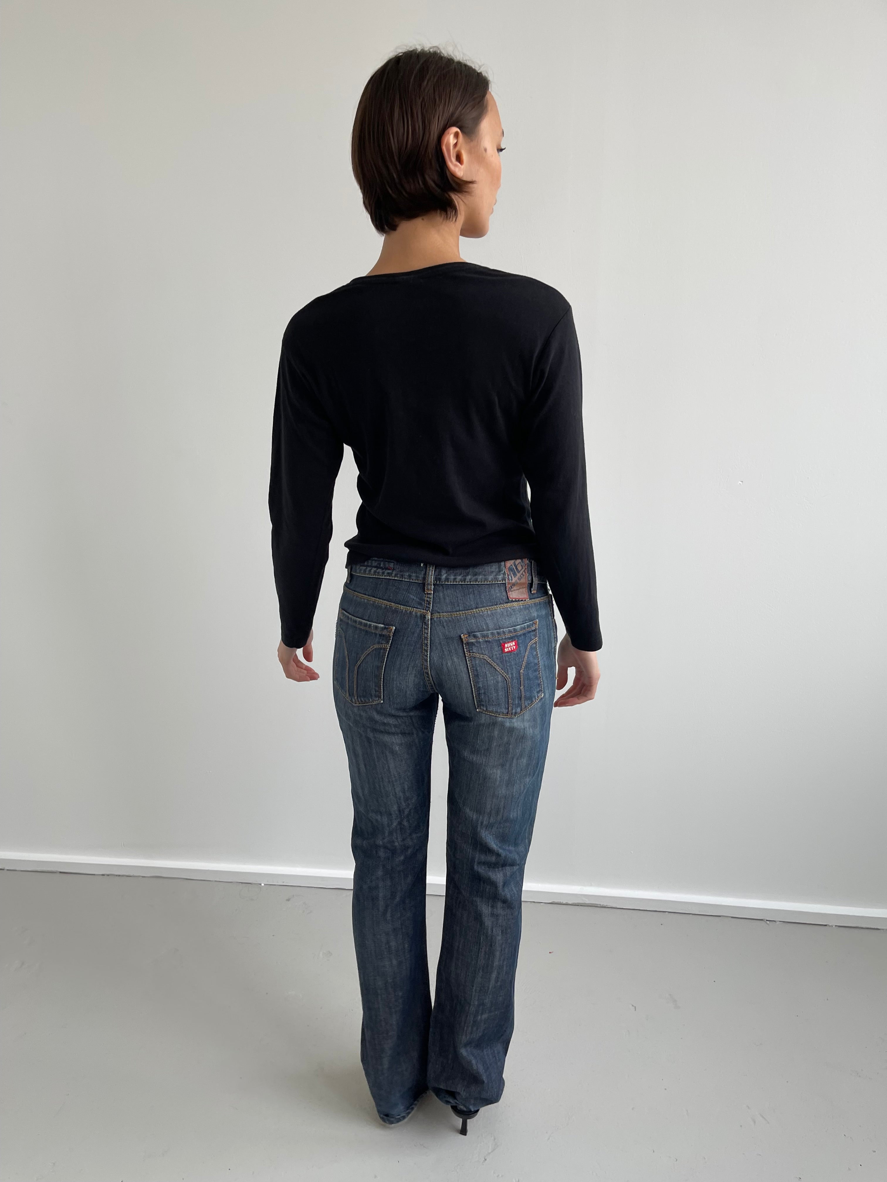 Black long sleeved top with silver cherub