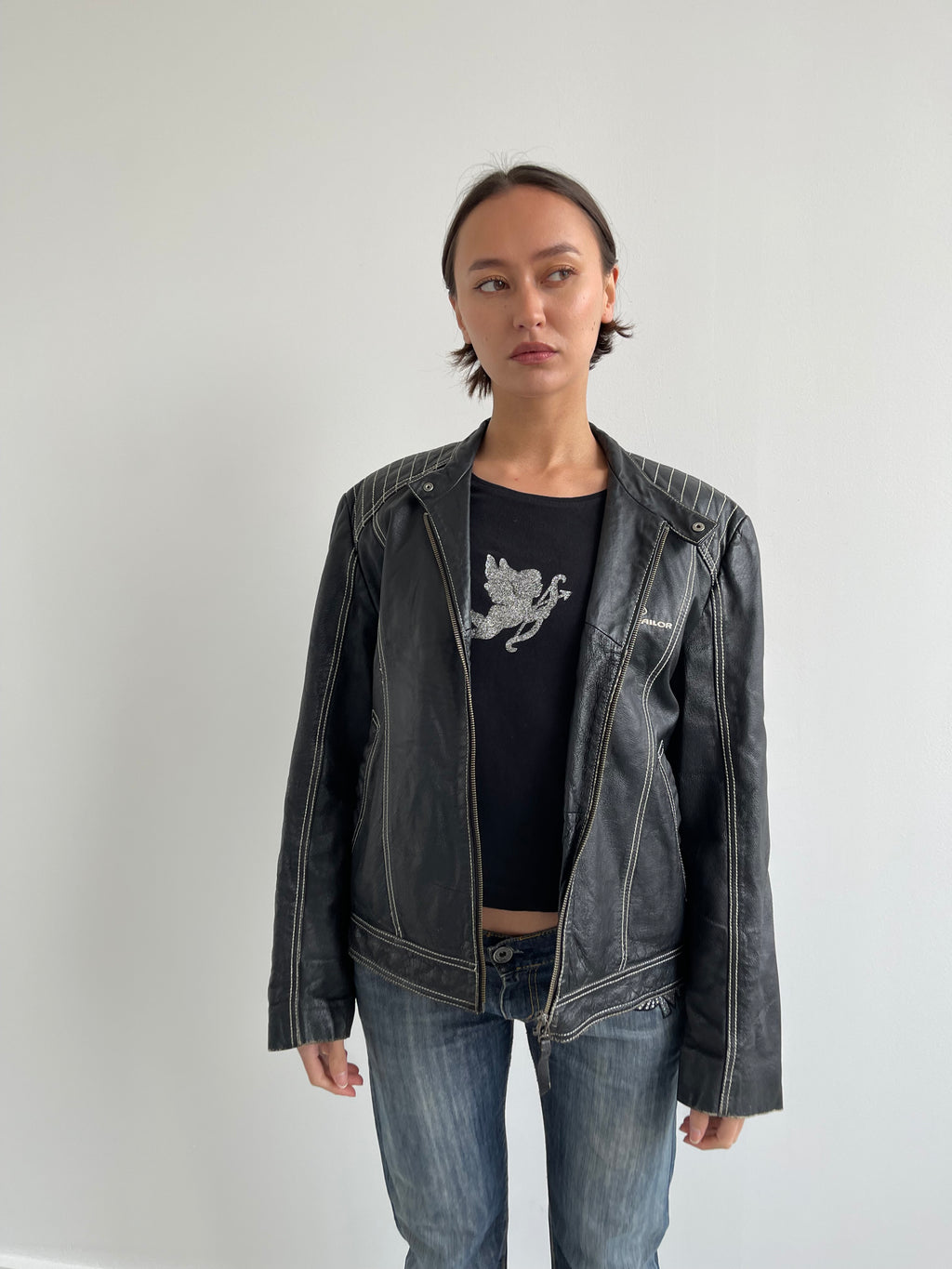 Vintage black leather biker jacket with cream top stitching