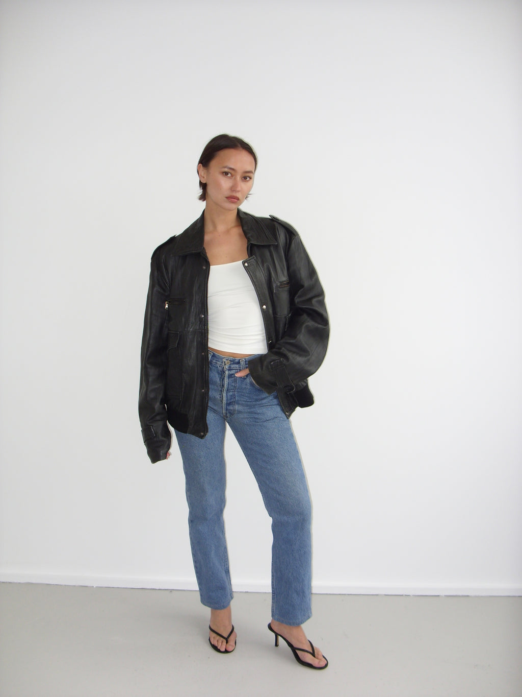 Oversized black leather bomber jacket
